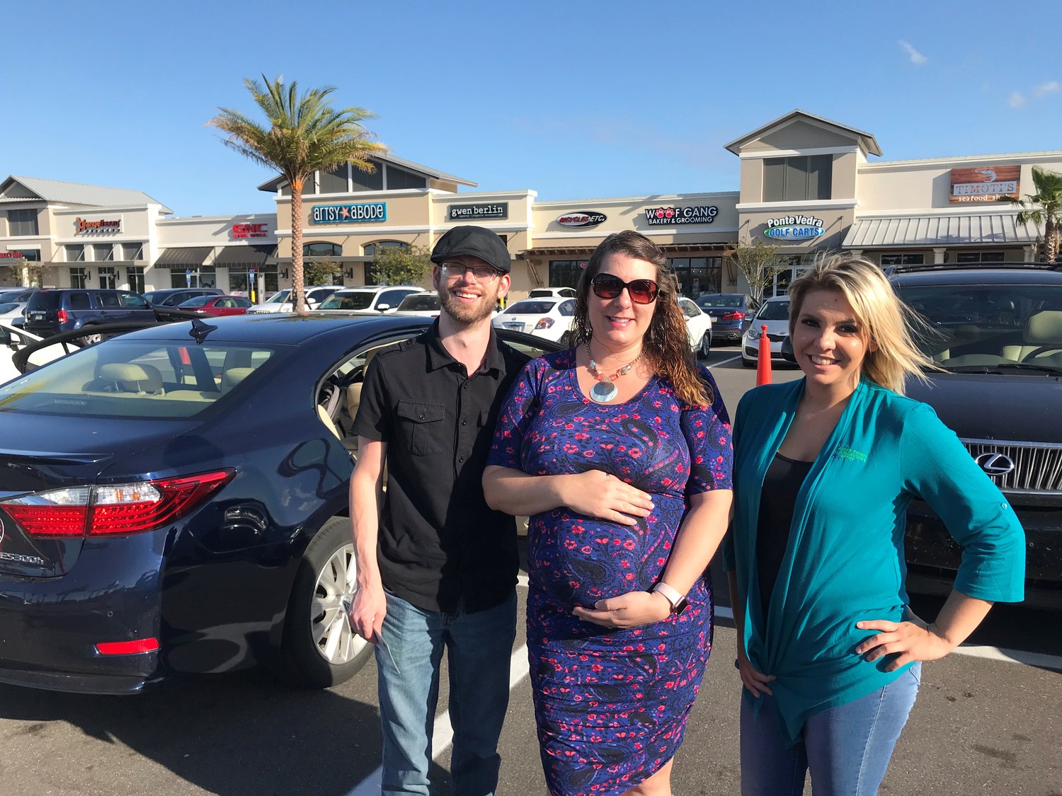 Nocatee residents Jonathan and Stephanie Feland (from left) gather with St. Johns County Tax Collector Office employee Whitney Graves at the May 2 car seat safety check hosted by REMAX Unlimited.